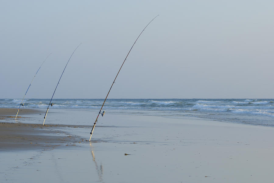 France, Le Porge beach, three fishing rods on beach, outdoors Photograph by Sami Sarkis