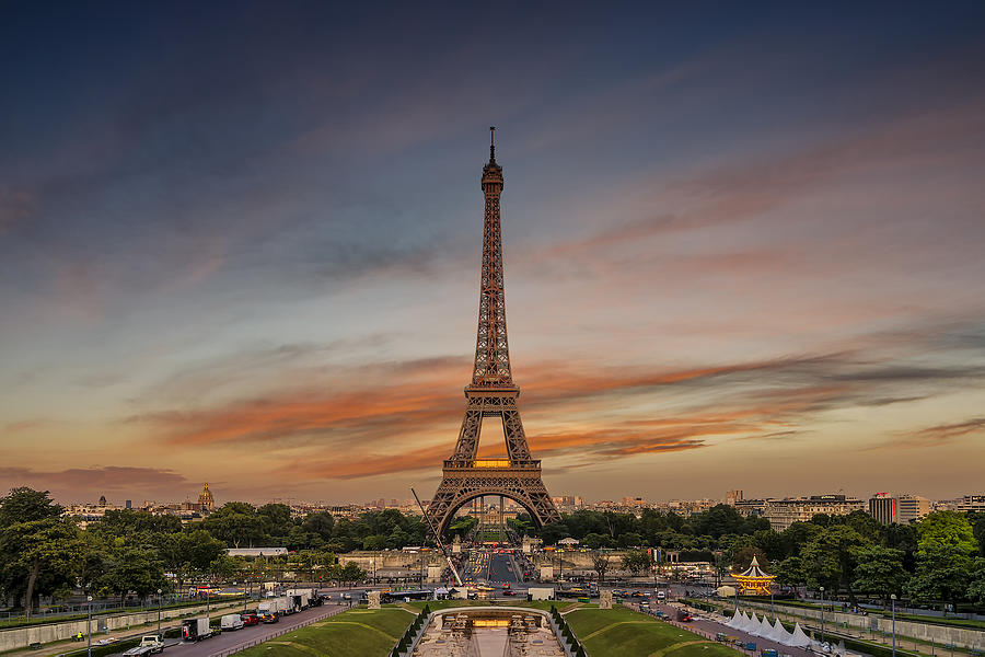 France, Paris, Eiffel Tower against moody sky Photograph by RilindH