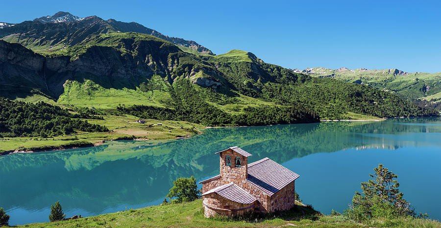 France - Roselend chapel in front of Roselend lake in Savoie Photograph by Olivier Parent