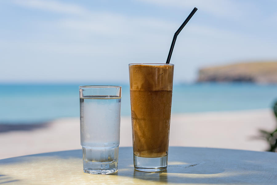 Frappe coffee drink served with a glass of water, Lesvos, Greece. Photograph by Malcolm P Chapman