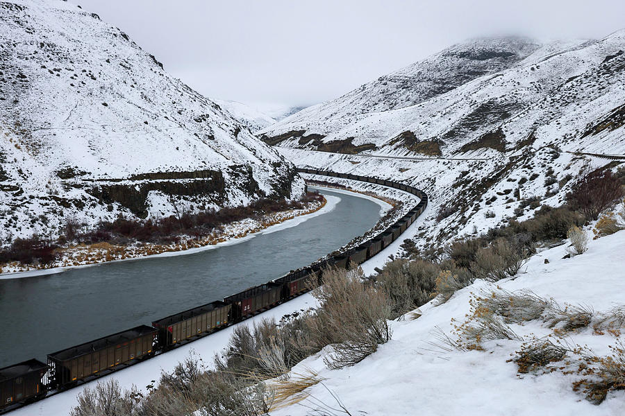 Freight cars rolling along the Yakima river Photograph by Jeff Swan
