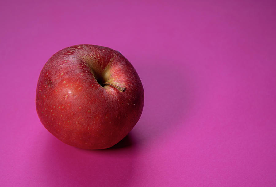 Fresh apple fruit isolated on a magenta background Photograph by Michalakis Ppalis