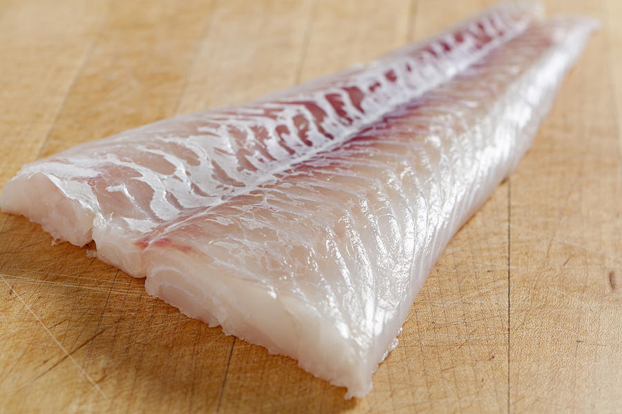 Fresh boneless skinless cod filet Photograph by Boblin