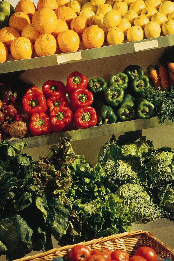 Fresh fruits and vegetables in grocery store Photograph by Comstock