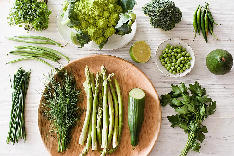 Fresh green vegetables on plate Photograph by Image Source