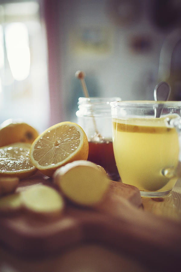 Fresh hot lemon with ginger prepared in a pretty country house kitchen Photograph by Rike_