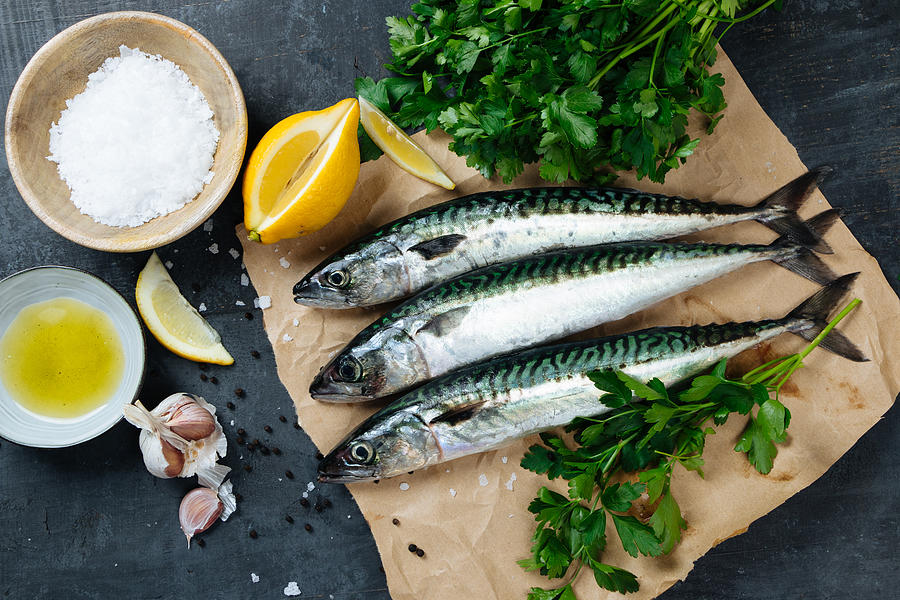 Fresh mackerel fish with ingredients to cook Photograph by Asife