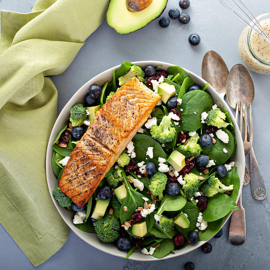 Fresh spinach and feta salad with salmon Photograph by VeselovaElena