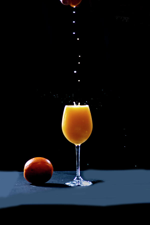 Fresh squeeze orange drops dripping in Photograph by Dan Friend