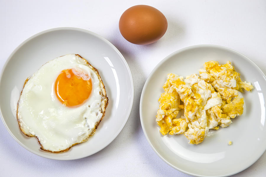 Fried egg on white plate and Scrambled eggs ion white plate for breakfast Photograph by Mikroman6