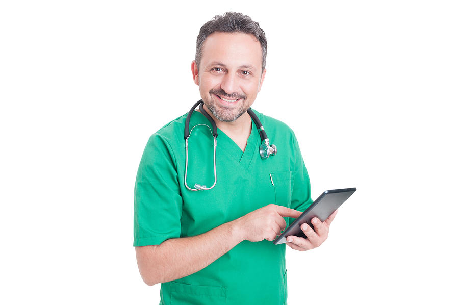 Friendly medical consultant holding tablet Photograph by Catalin205