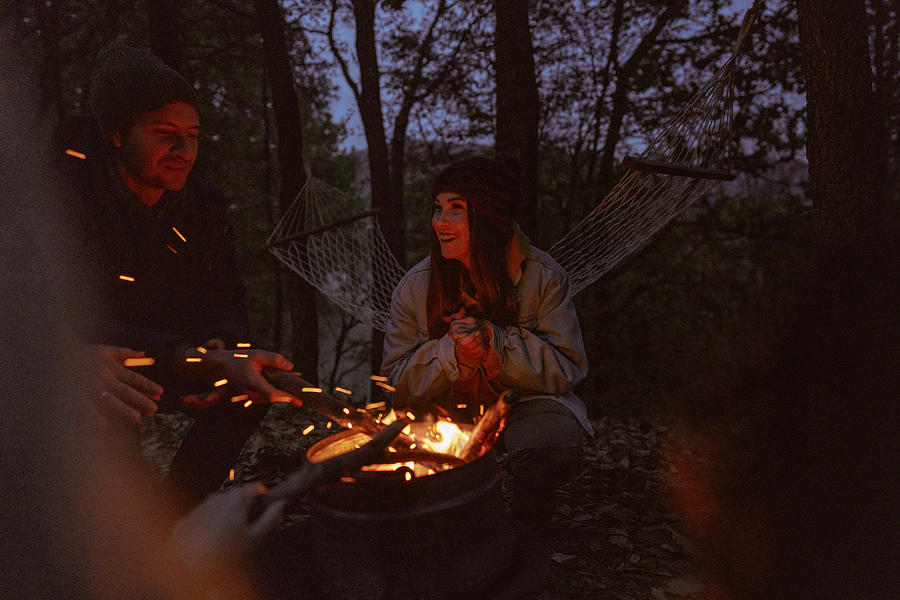 Friends enjoying by the campfire Photograph by AleksandarNakic