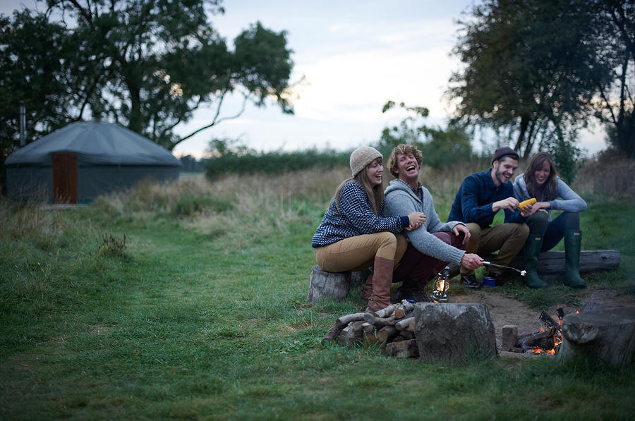 Friends sitting around campfire on glamping trip. Photograph by Mike Harrington