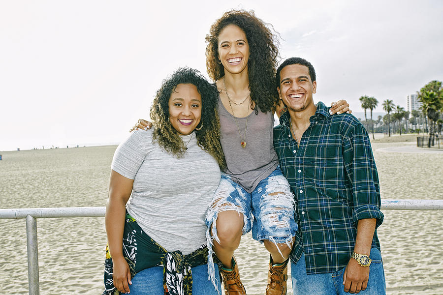 Friends smiling on beach Photograph by Peathegee Inc