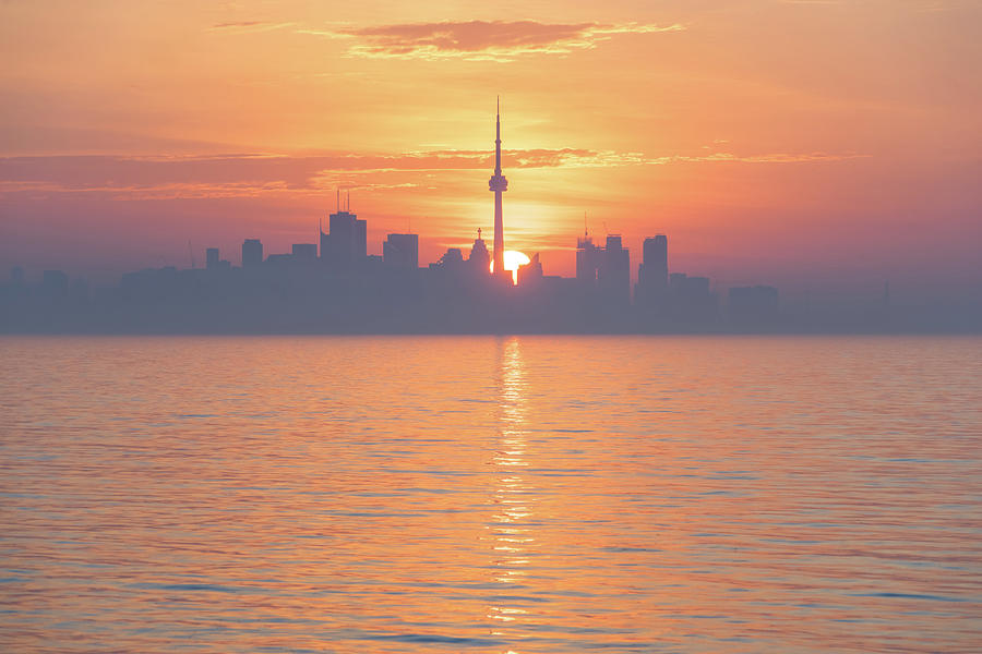 From Purple to Orange - Silhouetted Toronto Skyline Dividing the Rising Sun Disk Photograph by Georgia Mizuleva