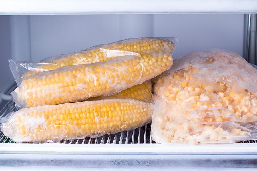 Frozen corn in bag in freezer close up Photograph by Qwart