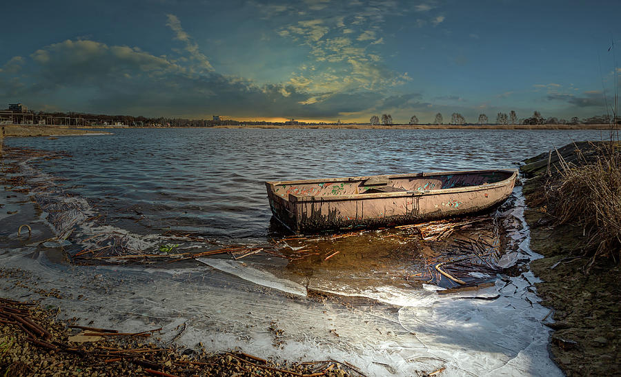 Frozen river /lonely boat/ end of the day  Photograph by Aleksandrs Drozdovs