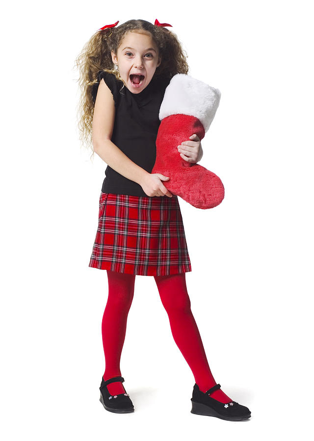 Full Body Shot Of A Female Child In A As She Holds Out A Red Christmas Stocking Photograph by Photodisc