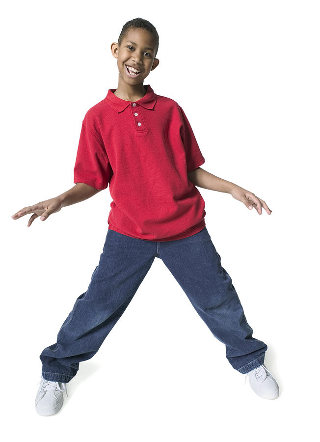 Full Body Shot Of A Male Child As He Spreads Out His Arms And Dances Photograph by Photodisc