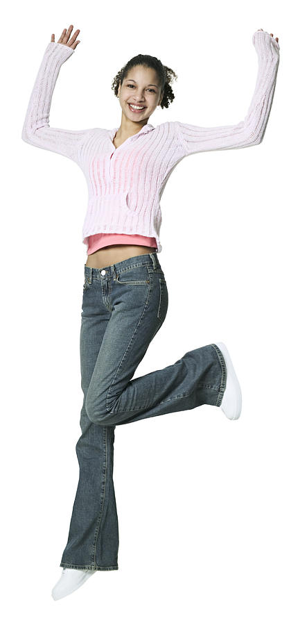 Full Body Shot Of A Teenage Female In A Pink Sweater As She Jumps Up Through The Air Photograph by Photodisc