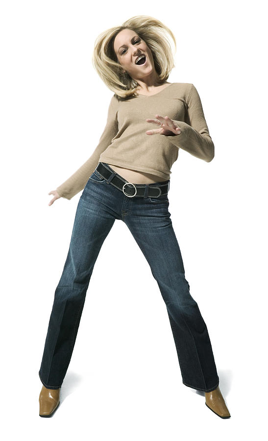 Full Body Shot Of A Young Adult Blonde Female In A Tan Sweater As She Playfully Dances Photograph by Photodisc