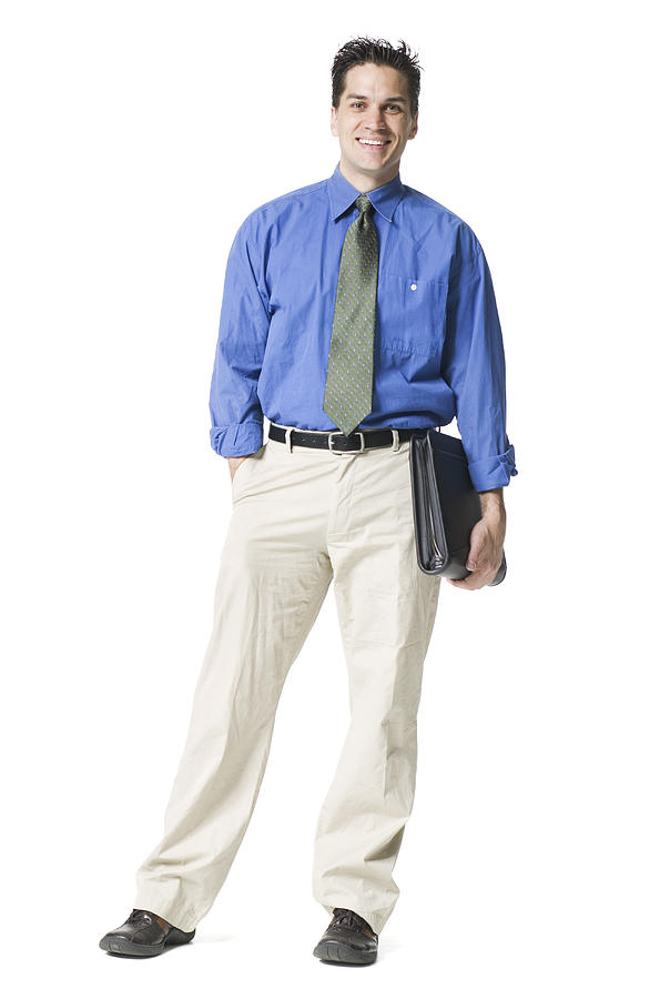 Full Body Shot Of A Young Adult Business Man In A Blue Shirt And Tie He Holds A Notebook And Smiles Photograph by Photodisc