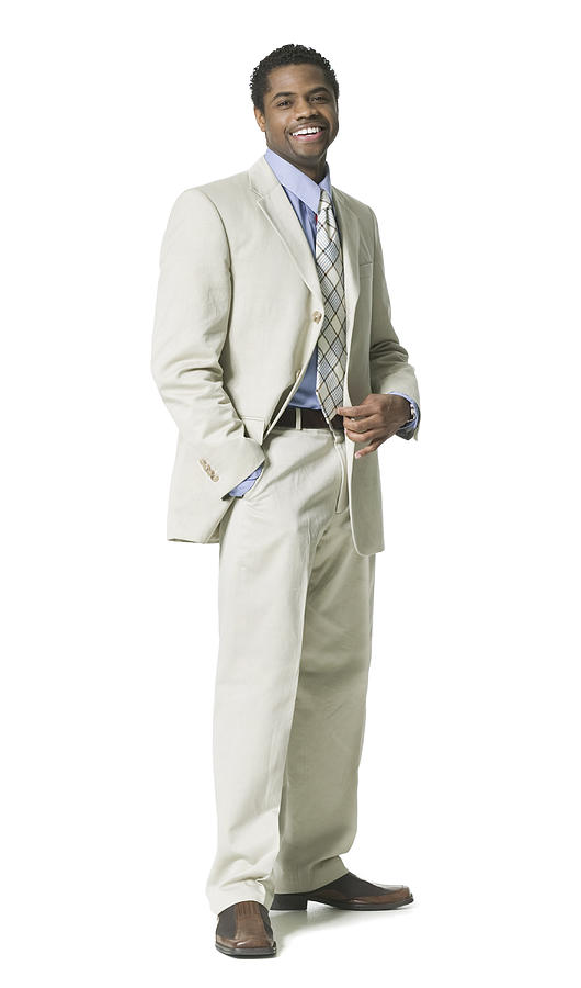 Full Body Shot Of A Young Adult Business Man In A Light Suit As He Smiles Photograph by Photodisc