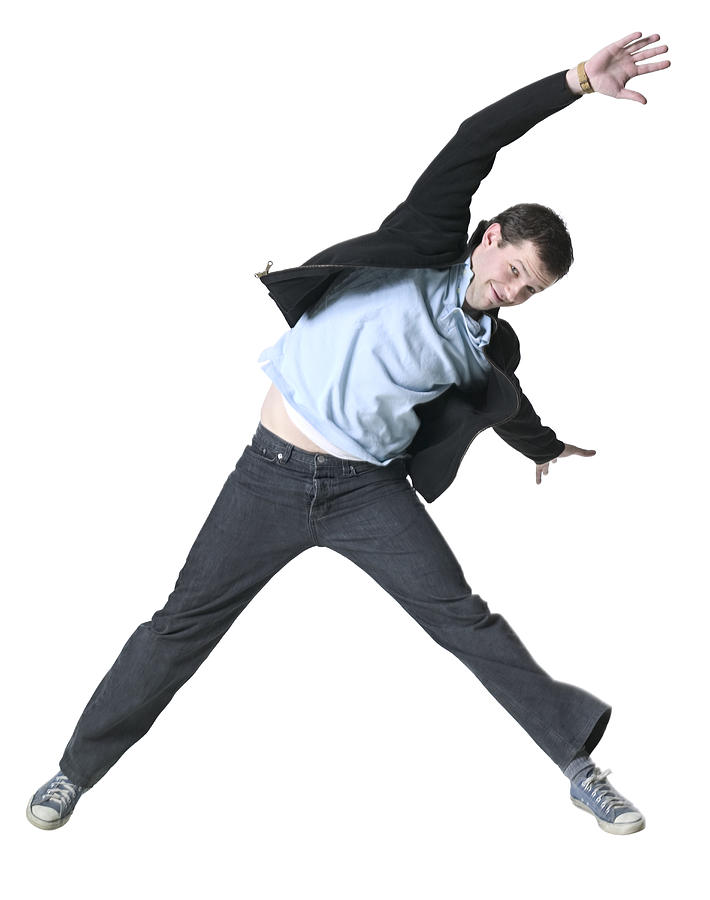 Full Body Shot Of A Young Adult Male In A Black Jacket As He Jumps Through The Air Photograph by Photodisc