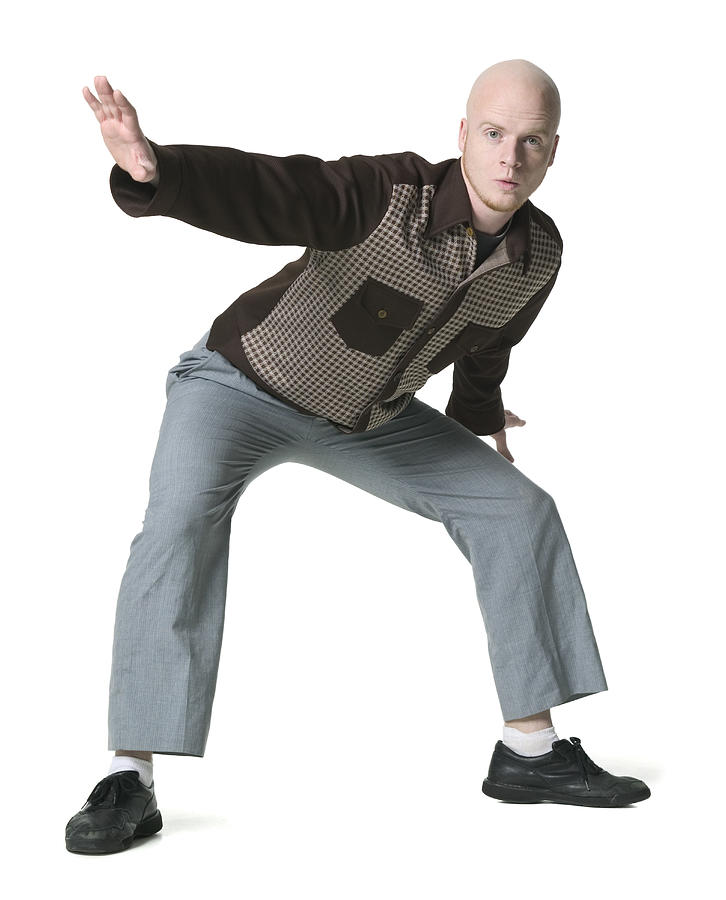 Full Body Shot Of A Young Adult Male In A Brown Checkered Shirt As He Strikes A Silly Pose Photograph by Photodisc