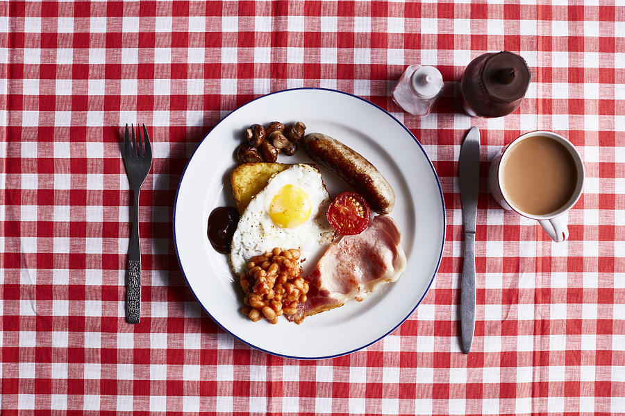 Full English breakfast on checked table cloth, overhead view Photograph by Debby Lewis-Harrison