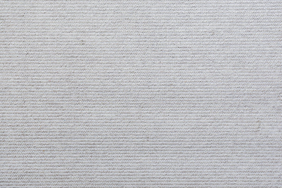 Full frame background of a light, almost white, carpet viewed from above. Photograph by Tuomas Lehtinen