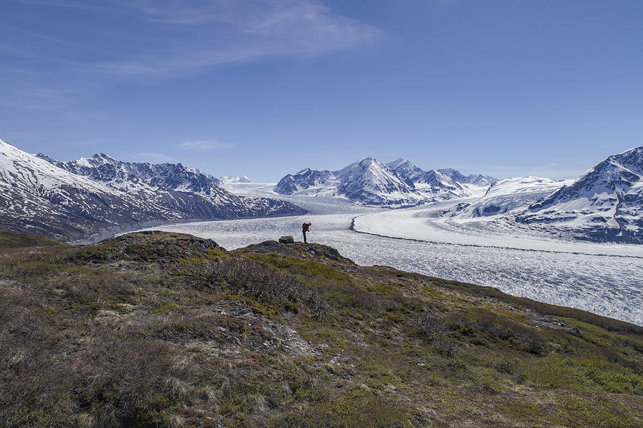 Full length of hiker looking at glacier against blue sky, Knik Glacier, Palmer, Alaska Photograph by Stephan Zirwes