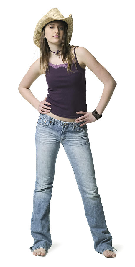 Full Length Shot Of A Teenage Female In A Purple Tank Top And Cowboy Hat As She Looks At The Camera Photograph by Photodisc