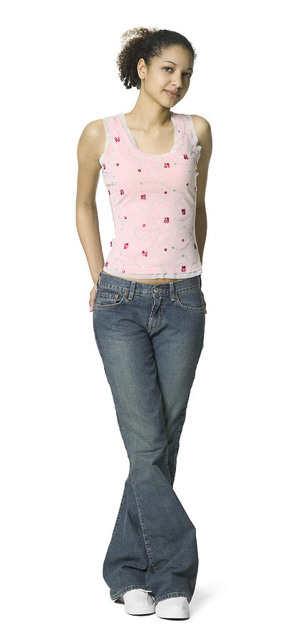 Full Length Shot Of A Teenage Female In Jeans And A Pink Shirt As She Smiles At The Camera Photograph by Photodisc