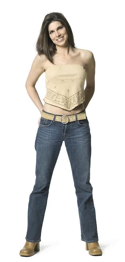 Full Length Shot Of An Attractive Adult Female In A Tan Shirt As She Smiles At The Camera Photograph by Photodisc