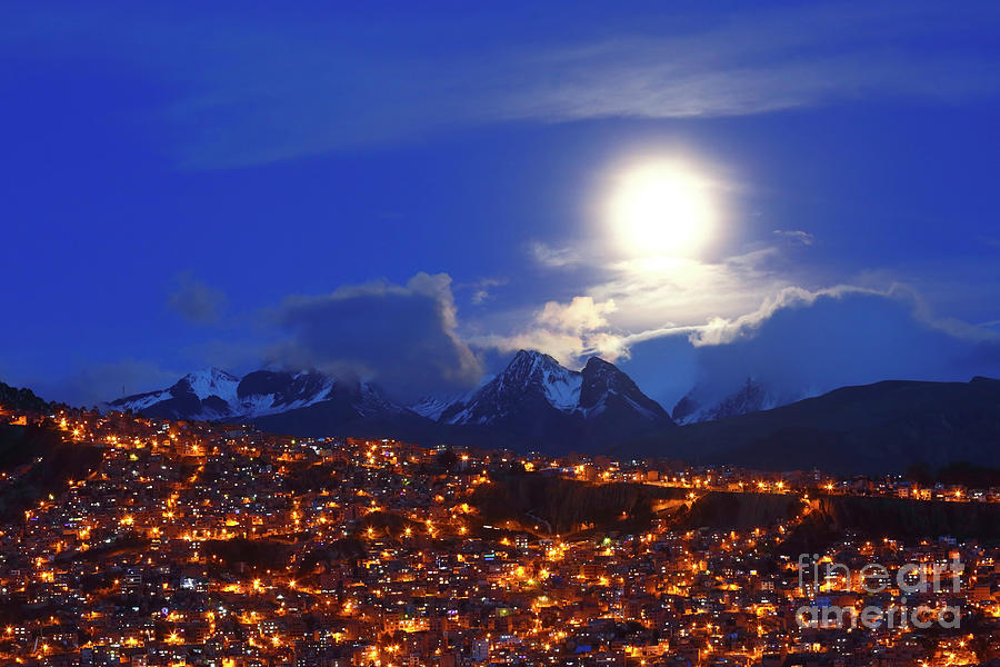 City Photograph - Full moon above the clouds city lights and mountains La Paz Bolivia by James Brunker
