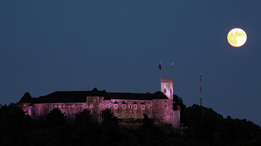Full moon beside Ljubljana Castle Photograph by Ian Middleton