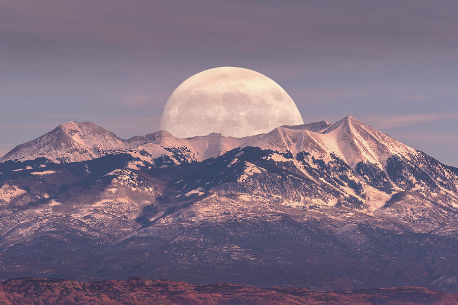 Full moon rising behind La Sal Mountains in Canyonlands National Park during sunset Photograph by Rod Gimenez