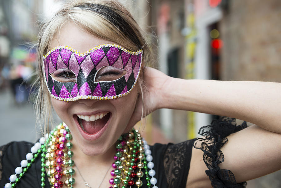 Fun-loving young woman at Mardi Gras in New Orleans Louisiana Photograph by Joel Carillet
