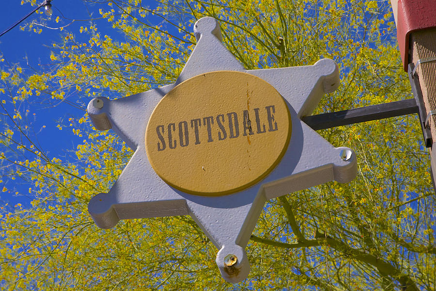 Fun sign with city name in center of badge in Old Town Scottsdale, AZ Photograph by Barry Winiker