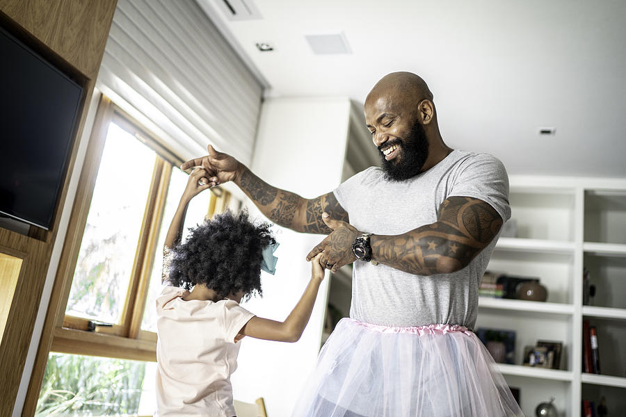 Funny father with tutu skirts dancing like ballerinas Photograph by FG Trade