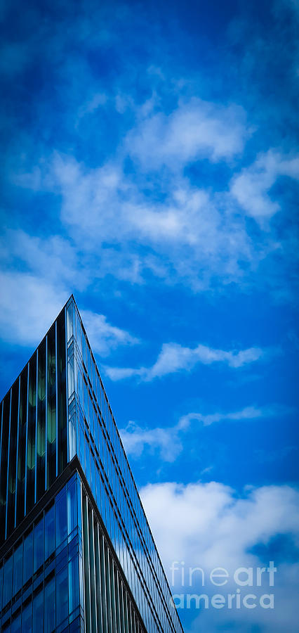 Futuristic triangular building against a clear blue sky Photograph by Mendelex Photography