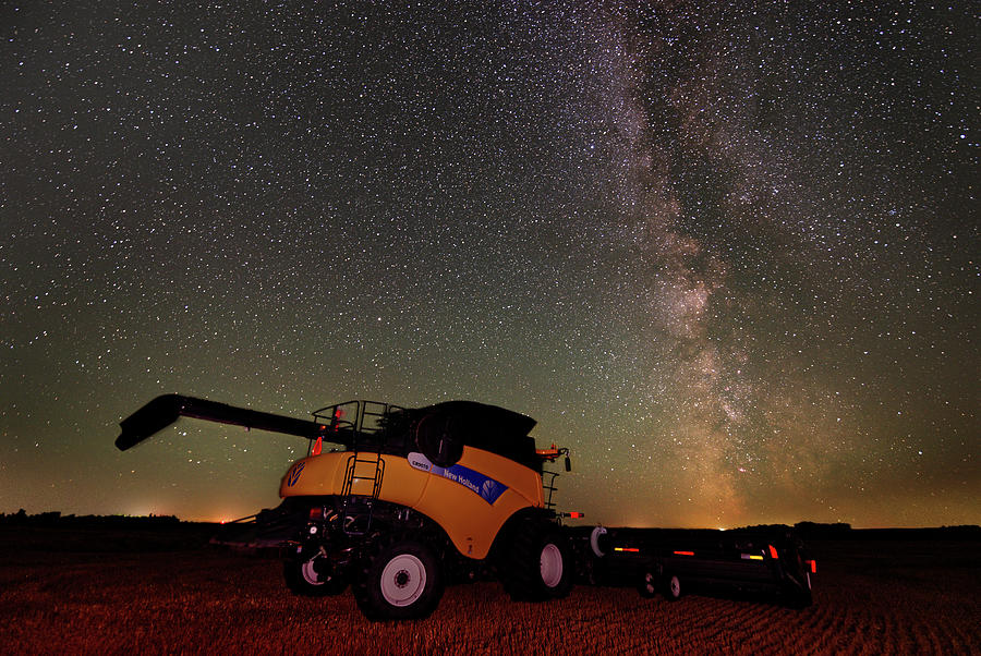 Galaxy Harvester - New Holland combine harvester in ND wheat field with milky way Photograph by Peter Herman