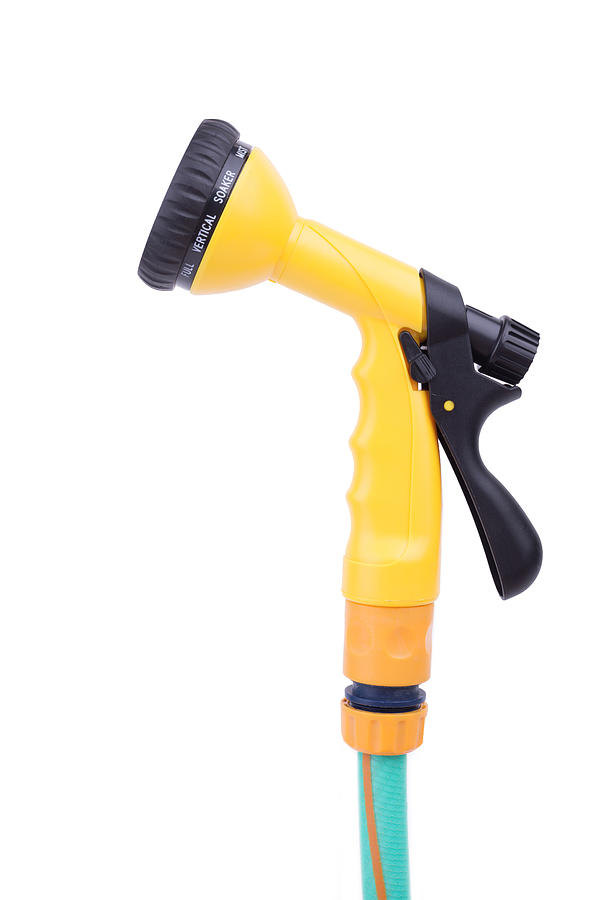 Garden nozzle Sprayer with adjustable water jet on a hose. Convenient sprayer for variable watering and cleaning tasks, isolated on white background Photograph by Yevgen Romanenko