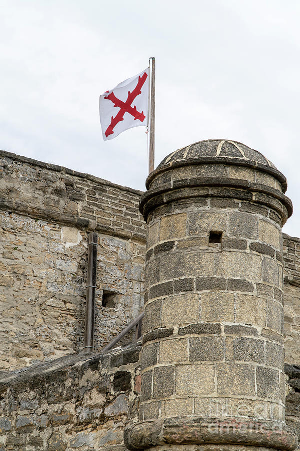 Garita, or sentry box, and Spanish flag at Fort Matanzas Nationa Photograph by William Kuta