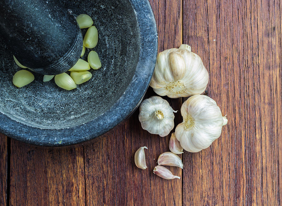 Garlic with Pestle and mortar Photograph by PorStock