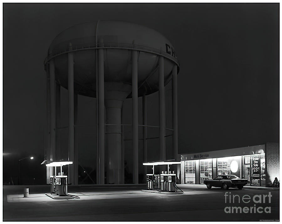 Gas station and water tower at night Photograph by Retrographs