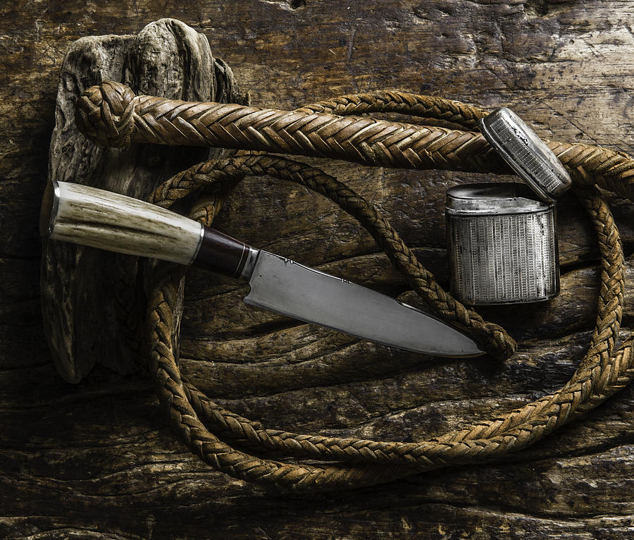 Gaucho knife, whip, silver cigarette case on wood. Still life Photograph by Images say more about me than words.