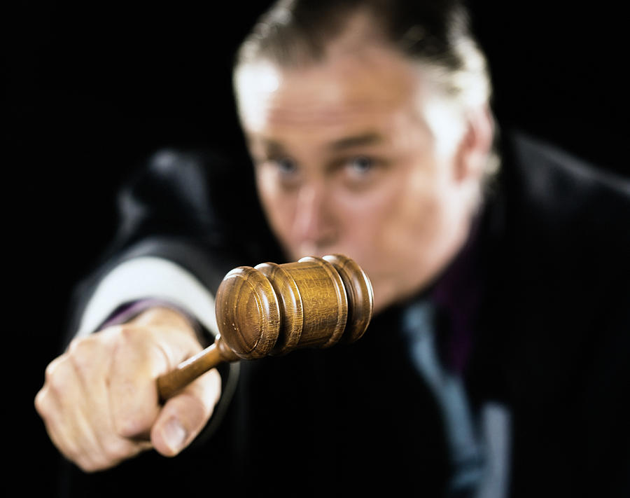 Gavel is held out as a threat by angry judge Photograph by RapidEye