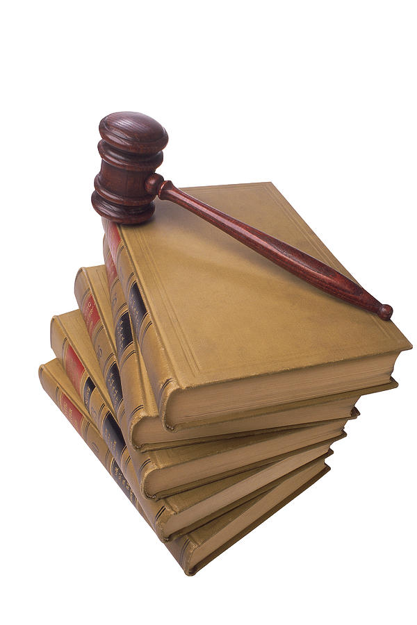 Gavel on stack of legal books Photograph by Comstock